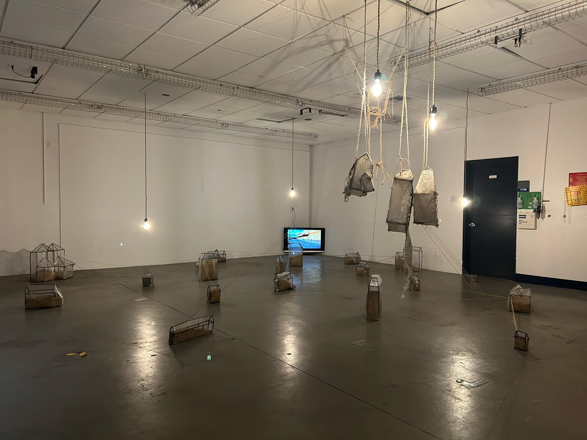01-01-2025 (2024), Rebar, Plastic, Lentils, Jute, T.V, Ink on Plastic, Single-channel HD Video, Stereo Sound, Continuous Loop, Rope Light Fixture, Led Bulbs